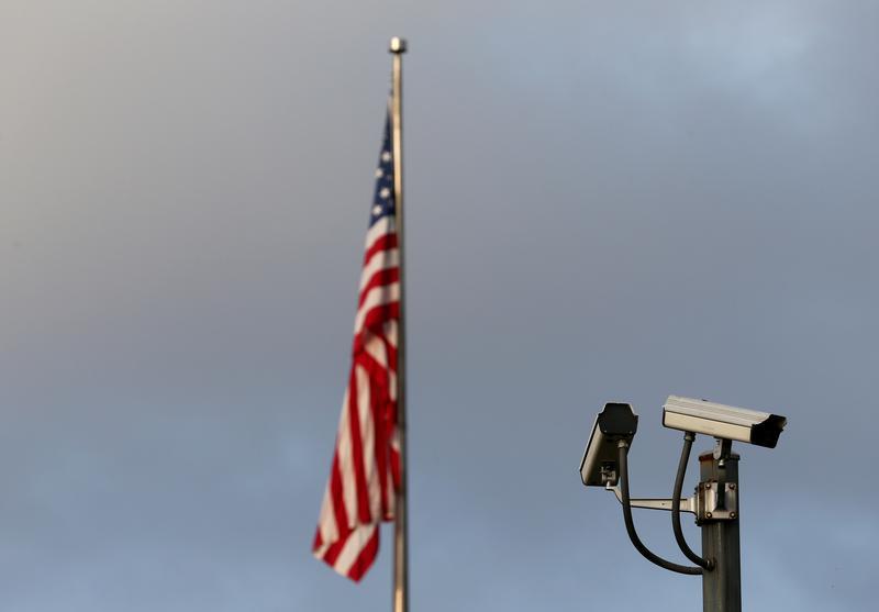A surveillance camera is pictured in front of the U.S. flag, September 20, 2016.