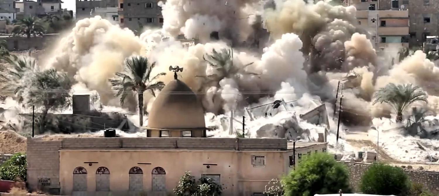 The Egyptian military destroys a building in Rafah, on the border with the Gaza Strip, during forced evictions between October 20-31, 2014.