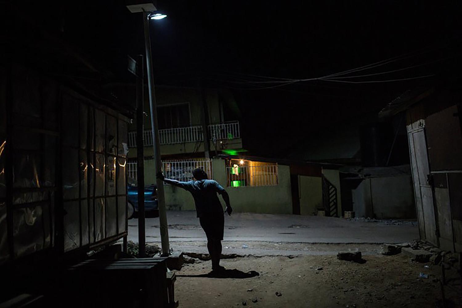A gay man in Bariga, a neighborhood in Lagos, Nigeria, who said he hides his identity from his friends and family.