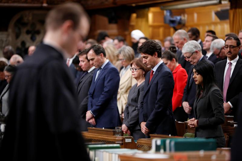 Canada's Prime Minister Justin Trudeau (front, 2nd R) joins fellow MPs in a moment of silence after delivering a statement on a deadly shooting at a Quebec City mosque, in the House of Commons on Parliament Hill in Ottawa, Ontario, Canada, January 30, 201