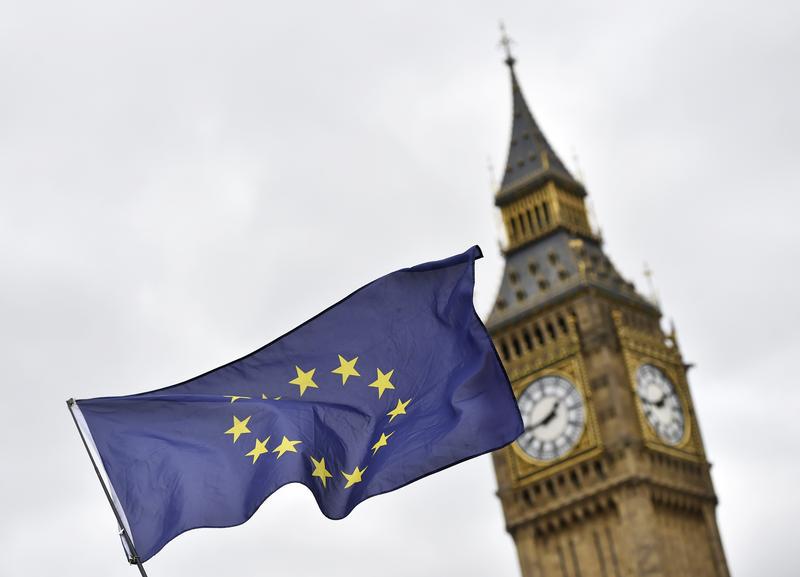 A protester waves a European Union flag outside Parliament after Britain's Prime Minister Theresa May triggered the process by which the United Kingdom will leave the Euopean Union, in London, March 29, 2017.