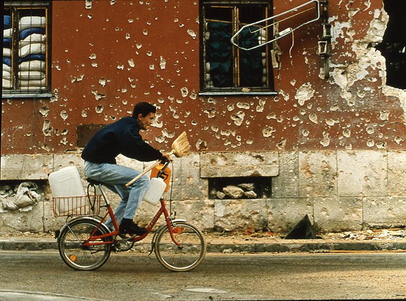 A boy going for water rushes across a dangerous intersection where some 20 people had, in recent weeks, been killed by snipers. Mostar was under siege and its residents were desperate for water. 