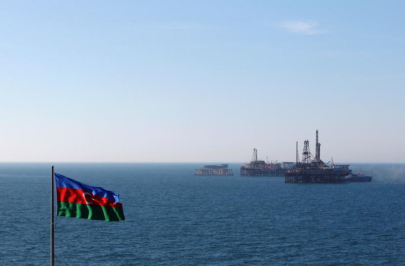 An Azerbaijan state flag flutters in the wind on an oil platform in the Caspian Sea east of Baku, January 22, 2013. 
