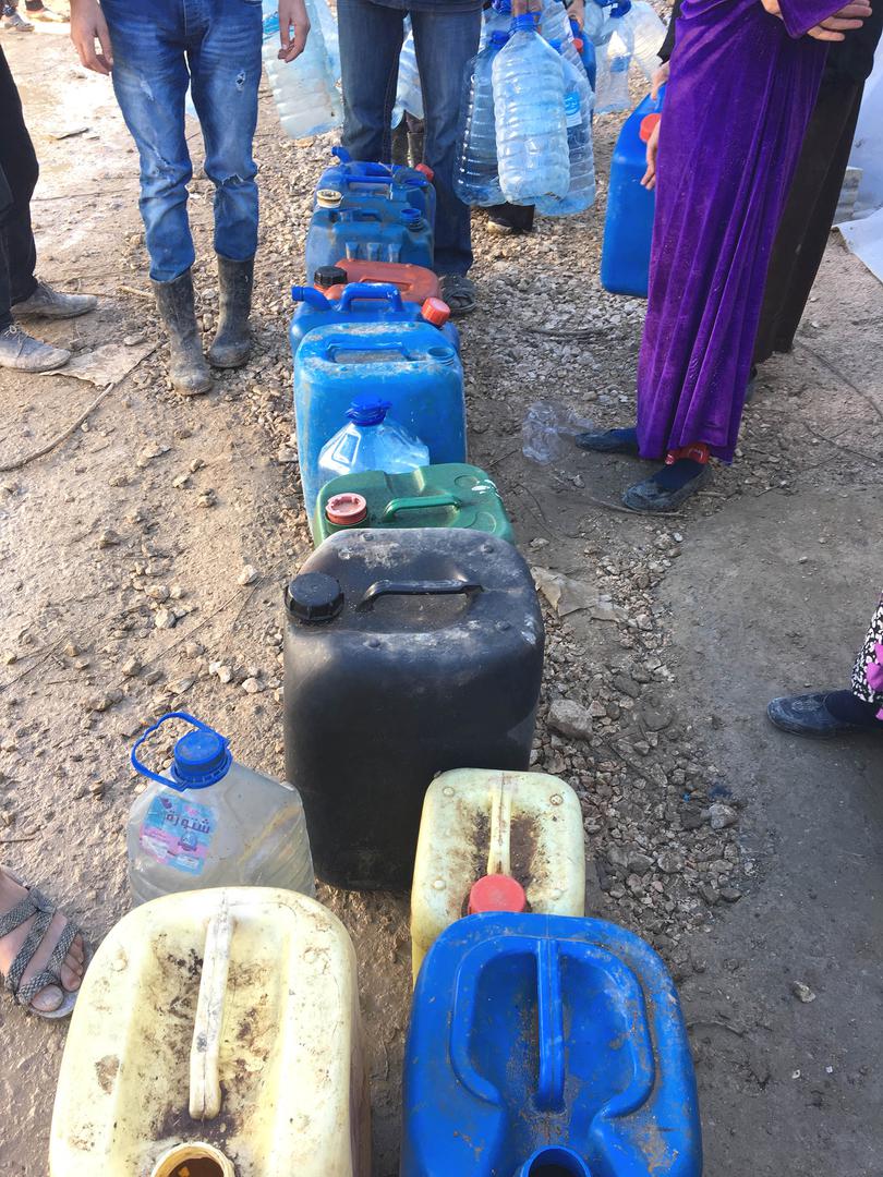 Residents wait for the delivery of humanitarian aid at an informal tented settlement that houses Syrian refugees evicted from the Rayak air base area in the Bekaa Valley, Lebanon.