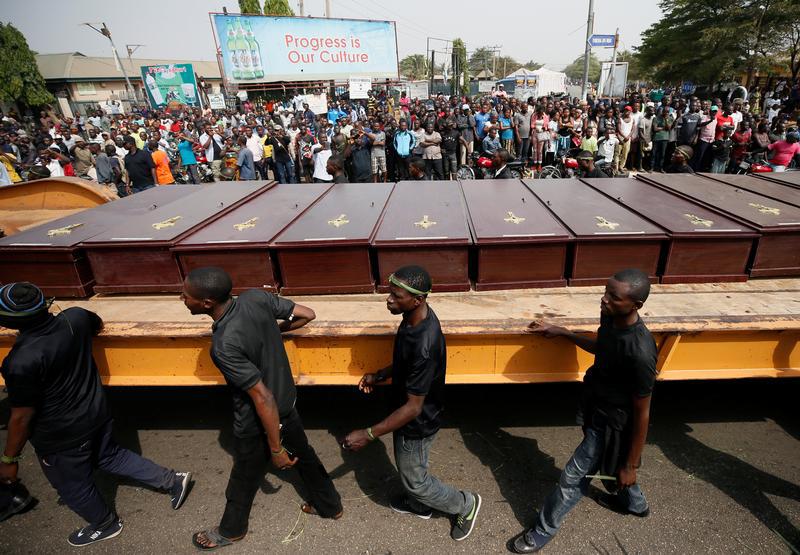 Men march along a truck carrying the coffins of people killed in Makurdi, Nigeria January 11, 2018. 