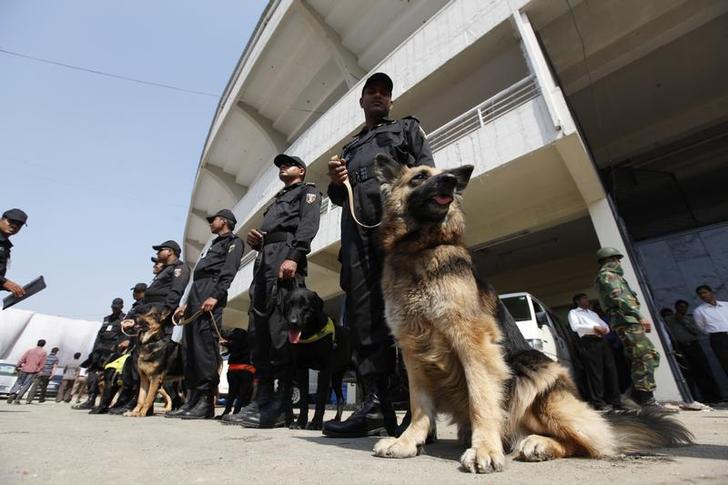 Members of Rapid Action Battalion (RAB) stand guard with dogs in Dhaka, Bangladesh, February 12, 2011.