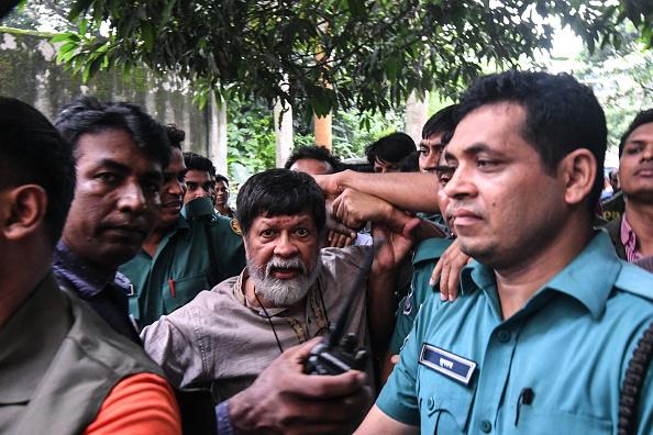 Activist and photographer Shahidul Alam arrives surrounded by policemen for an appearance in a court, in Dhaka, Bangladesh on August 6, 2018. 