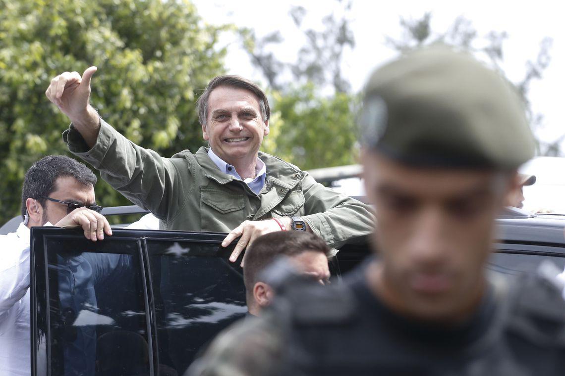 El candidato a la presidencia de Brasil por el Partido Social Liberal (PSL), Jair Bolsonaro, vota el 28 de octubre en la Escuela Municipal Rosa da Fonseca en Río de Janeiro, protegido por agentes de la Policía Federal.