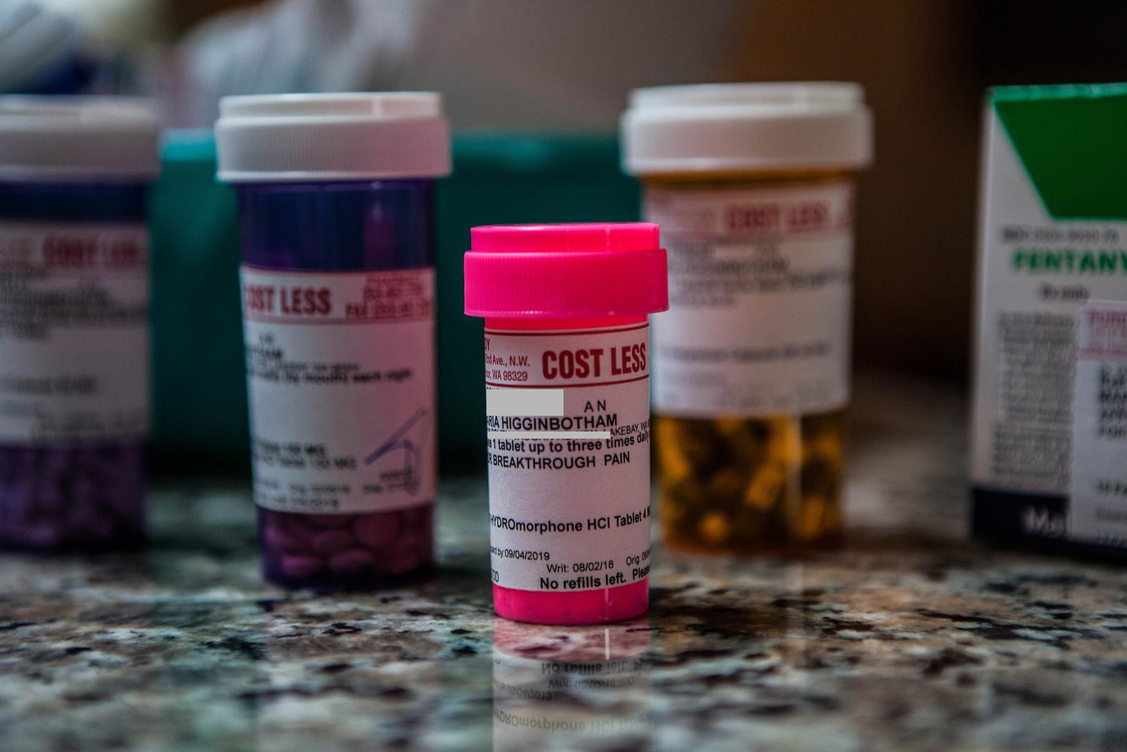 Maria Higginbotham’s medication bottles, including hydromorphone, an opioid she uses for breakthrough pain. 