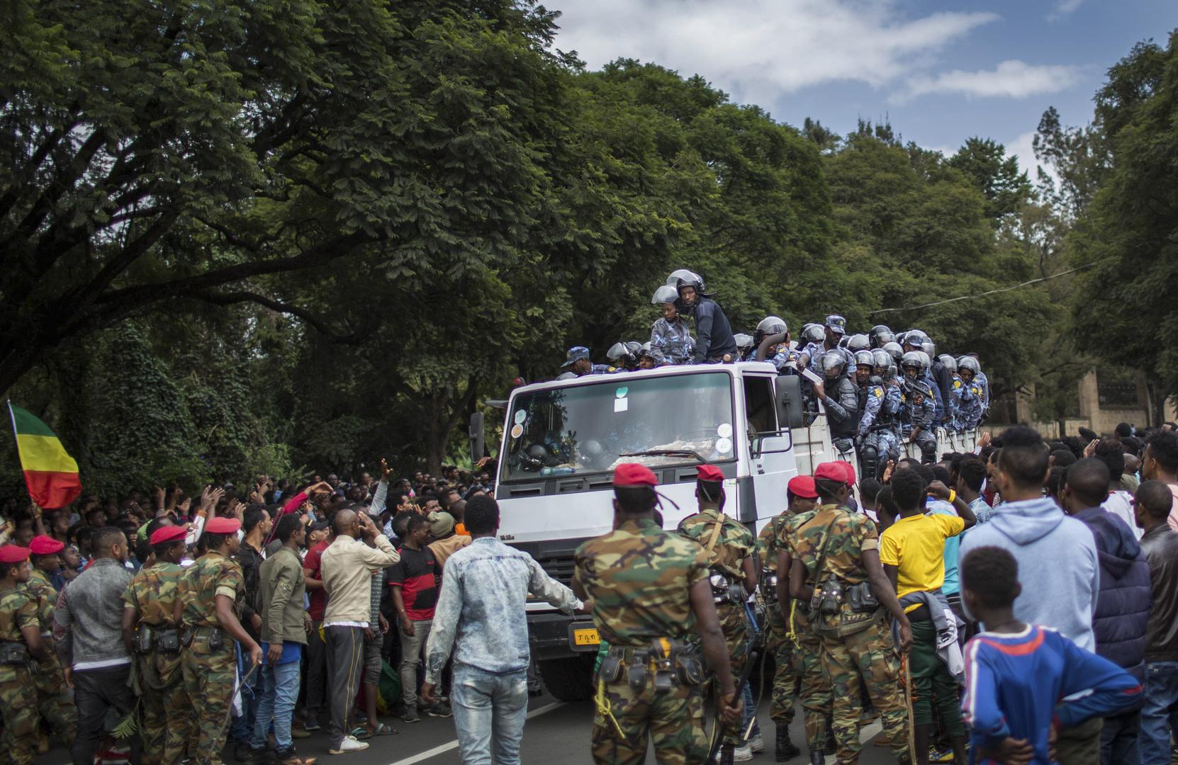 Members of the army and riot police attempt to control protestors from the capital and those displaced by ethnic-based violence over the weekend in Burayu, as they demonstrate to demand justice from the government in Addis Ababa, Ethiopia Monday, Sept. 17