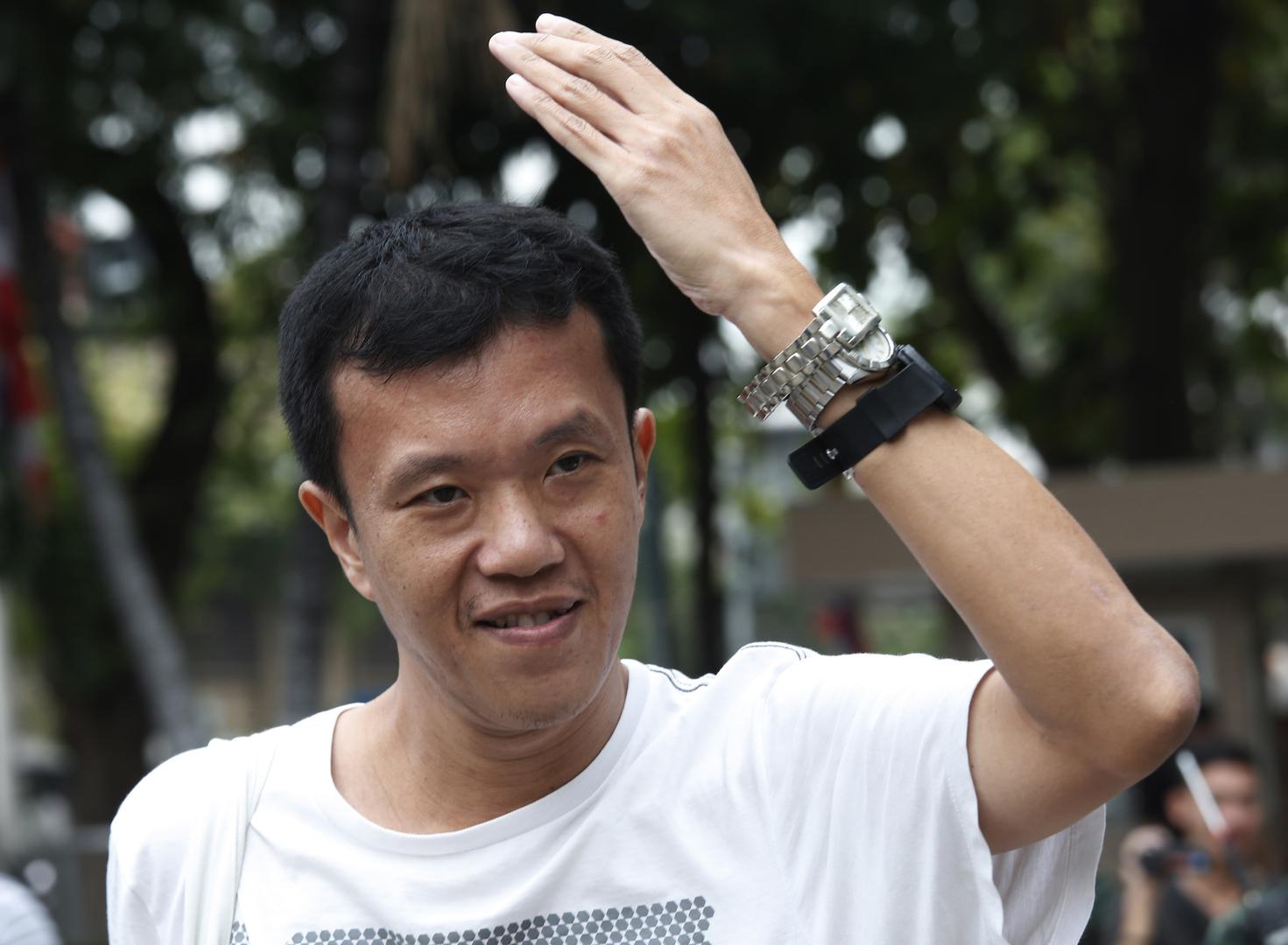 In this January 11, 2018, photo, activist Ekachai Hongkangwan show his watches during a demonstration highlighting the corruption allegations against Deputy Prime Minister Prawit Wongsuwan in front of Government House. 