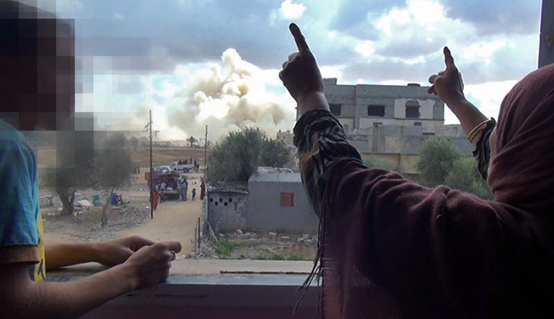 A woman yells as a neighbor’s house is destroyed. © 2014 Private