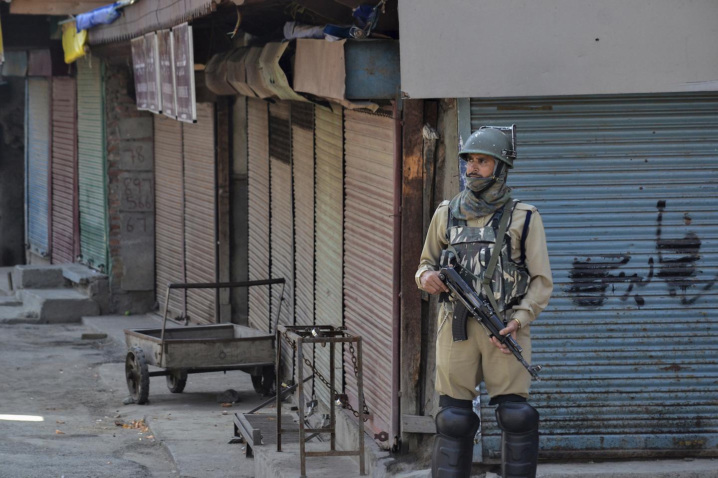A paramilitary trooper stands guard during shutdown in Srinagar, Kashmir. 