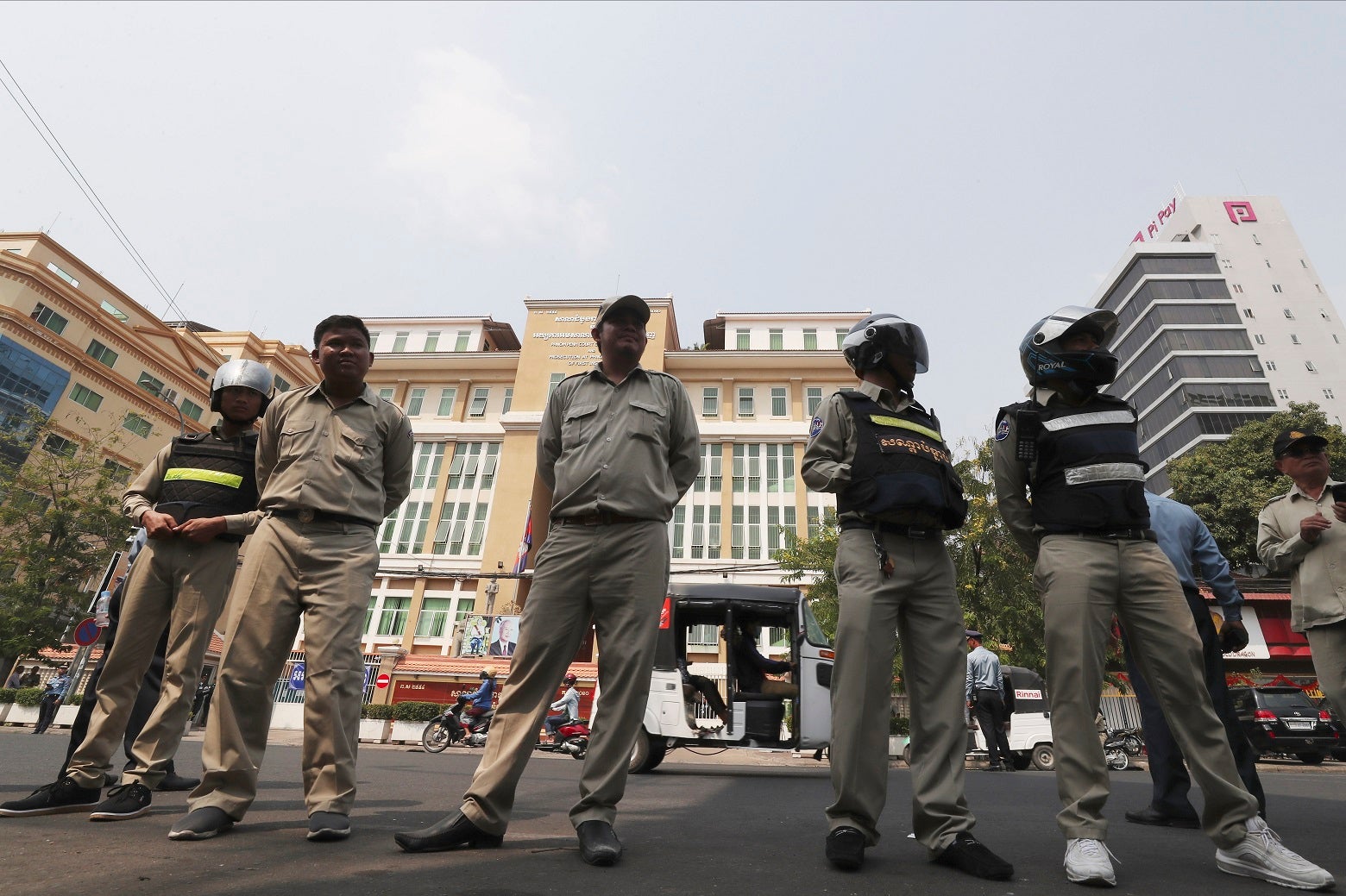 Cambodian police officers stand guard in front of the Phnom Penh Municipal Court during a hearing of Kem Sokha, the head of the dissolved Cambodia National Rescue Party, in Phnom Penh, Cambodia, Thursday, Jan. 16, 2020. The trial of the top Cambodian oppo
