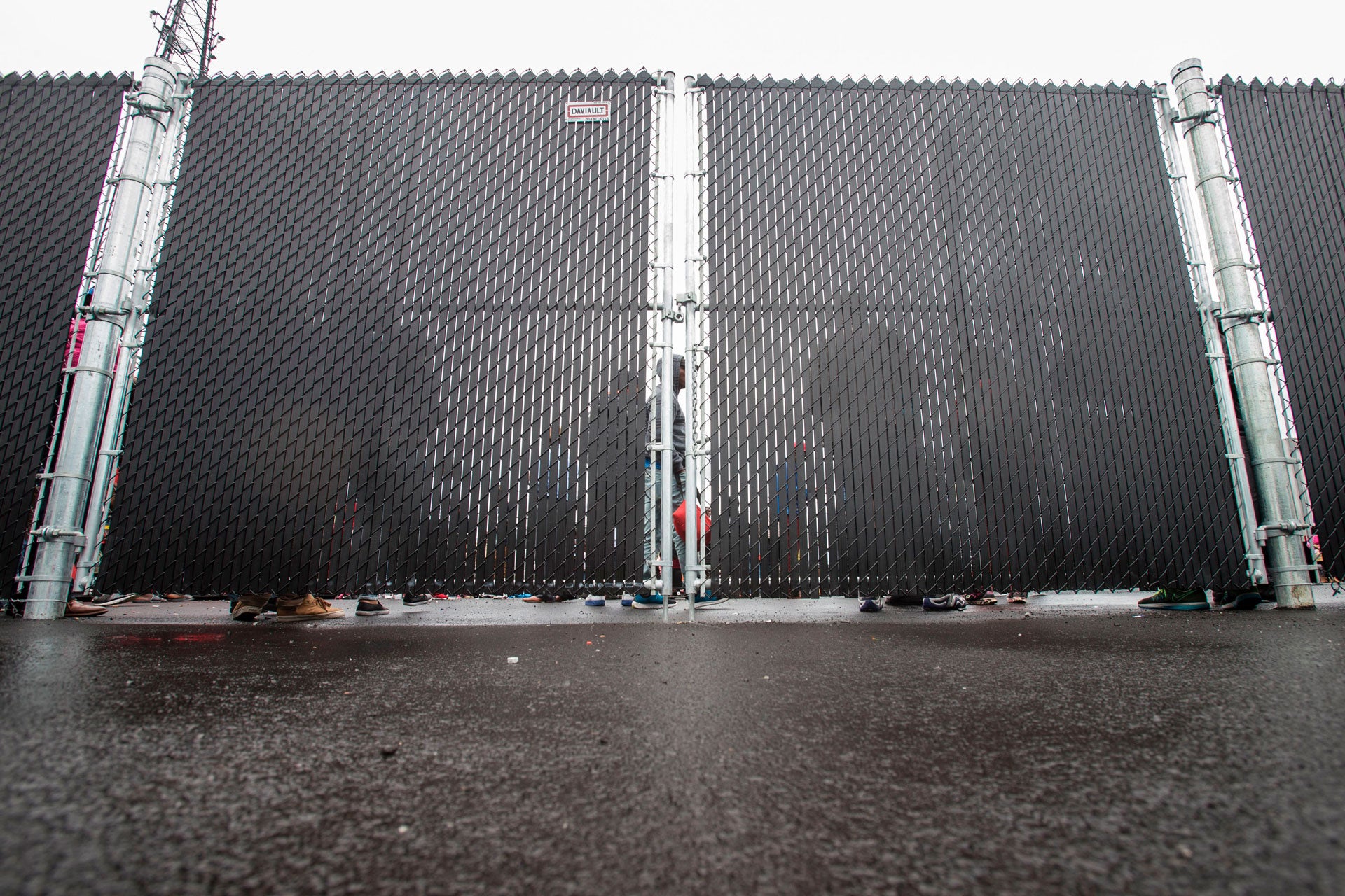 People wait in a temporary detention center in Blackpool, Quebec, August 5, 2017.