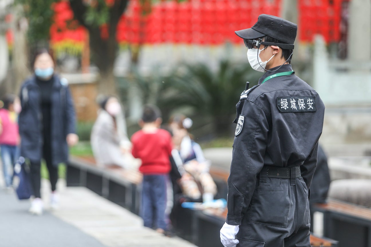 A security guard monitors people through his augmented reality eyewear equipped with an infrared temperature detector in Hangzhou, China, March 24, 2020.