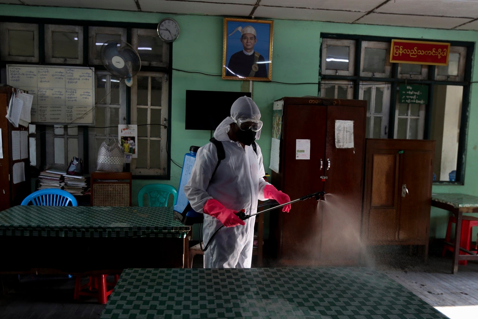A member of the Yangon City and Development Committee disinfects government offices to help curb the spread of the new coronavirus in Yangon, Myanmar Wednesday, March 25, 2020. 