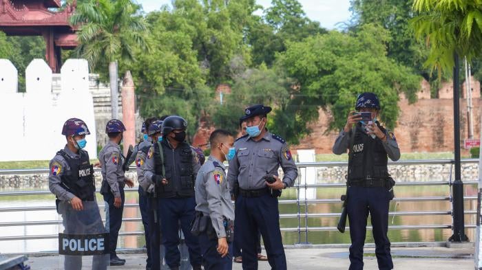 Police officers wearing facemasks stand on a street in Yangon, Myanmar, November 3, 2020. 