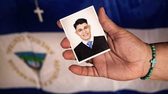 Lesbia Alfaro, mother of student leader Lester Alemán, who went into exile after participating in protests against Nicaraguan President Daniel Ortega's government in 2018, holds a portrait of her son during an interview with AFP in Managua, on September 14, 2021.