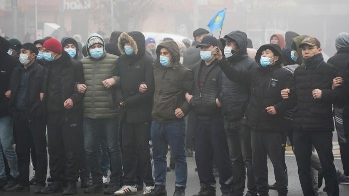 Demonstrators stand in front of a police line during a protest in Almaty, Kazakhstan, January 5, 2022.