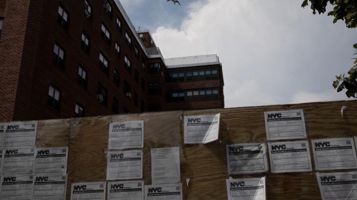 Work permits displayed in front of an apartment complex