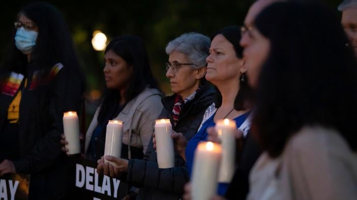 Activists hold a candlelight vigil
