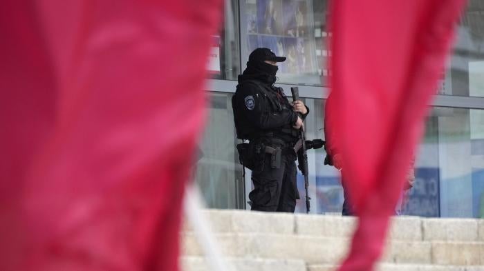 A Russian officer guards a polling station in the city of Luhansk, Ukraine, which is occupied by Russia.