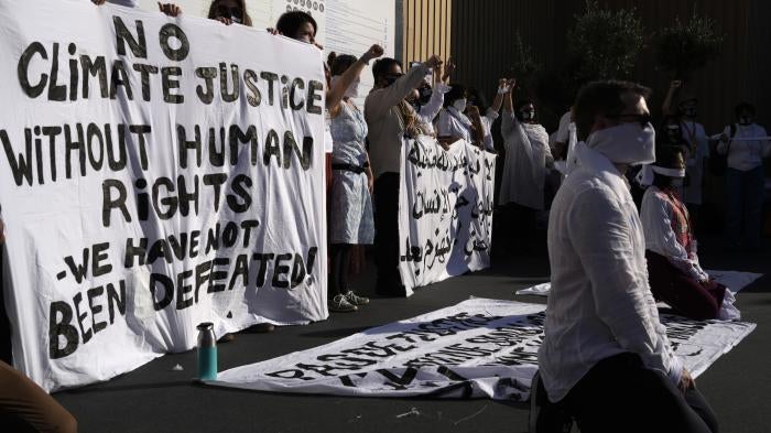 Demonstrators participate in a silent protest at the COP27.