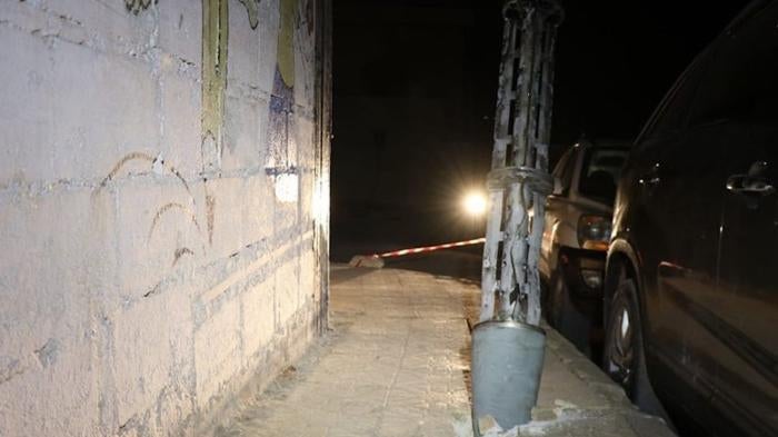 Remnant of an expended cargo section of one of the two 220mm 9M27K-series Uragan surface-launched cluster munition rockets embedded into the ground after it scattered its payload of explosive submunitions on a sidewalk next to a boys’ school in the town of Termanin, Syria 2023.