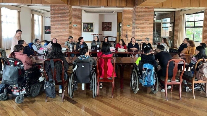Disability rights activists sit around a table for a meeting