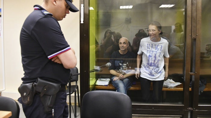 Defendants Alexander Dotsenko (L) and Anastasia Dyudyayeva, in a courtroom hearing accused of incitement to terrorism for leaving anti-war notes in a supermarket, St. Petersburg, Russia, July 18, 2024.
