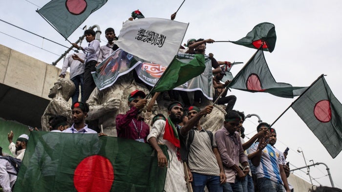 A group of people waving flags at a protest