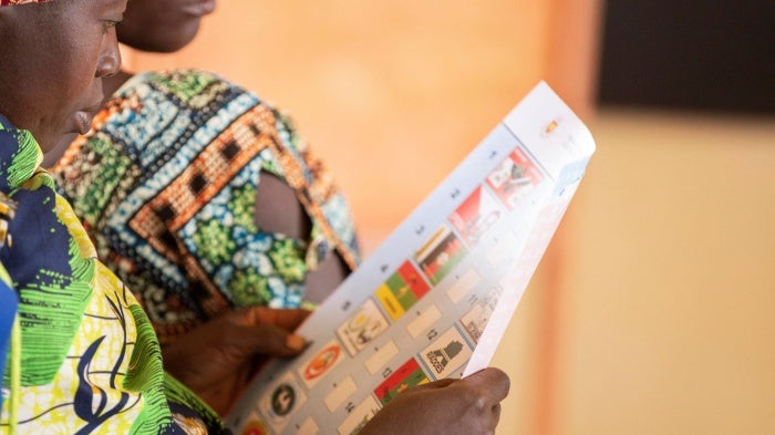 A woman looks at a ballot paper in Giheta Commune of Gitega Province in Burundi