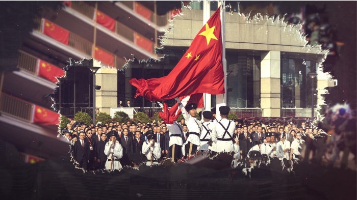 A Hong Kong police guard of honor rises China and Hong Kong flags during a flag raising ceremony.