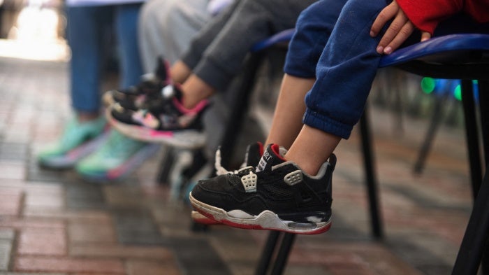 Deported children, along with their parents, sit in a migration office after being processed by staff of the Guatemalan Immigration Institute after arriving on deportation flights from the United States and Mexico, in Guatemala City, Guatemala, January 23, 2024.