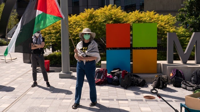 A demonstrator holds a Palestinian flag during a protest at the Microsoft Campus in Redmond, Washington, US, August 19, 2025.