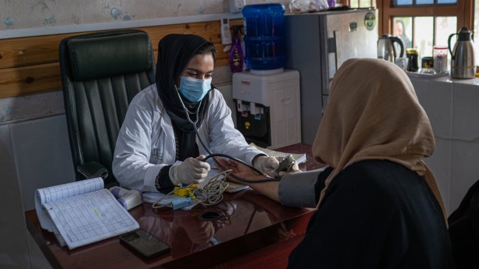 A doctor working with a UN agency examines a woman at a clinic in Herat, Afghanistan, July 5, 2025.