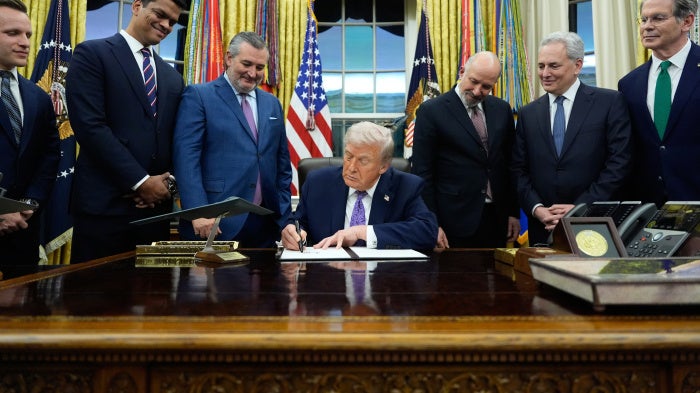 US President Donald Trump signs an Al initiative in the Oval Office of the White House, Washington DC, December 11, 2025.