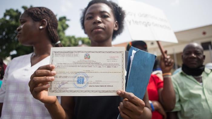 Elena Lorac, a spokesperson from the Reconoci.do movement, shows a birth certificate issued by the Central Electoral Board, during a rally in front of the Presidential Palace in Santo Domingo, July 12, 2013. 