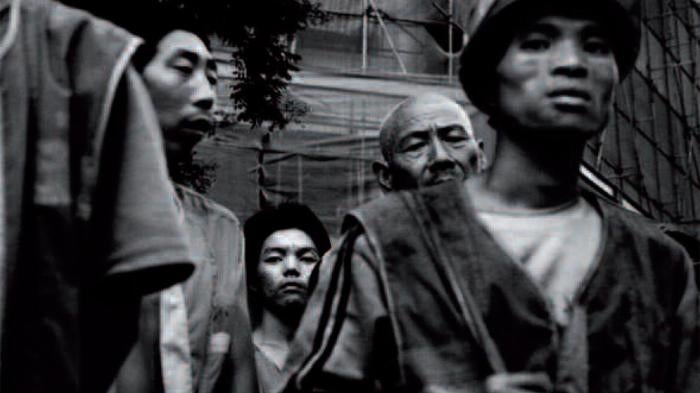 Migrant workers wait for buses to transport them to construction sites in Beijing.
