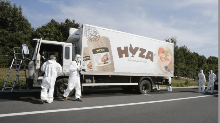 Forensic police officers inspect a parked truck in which up to 50 migrants were found dead, on a motorway near Parndorf, Austria August 27, 2015