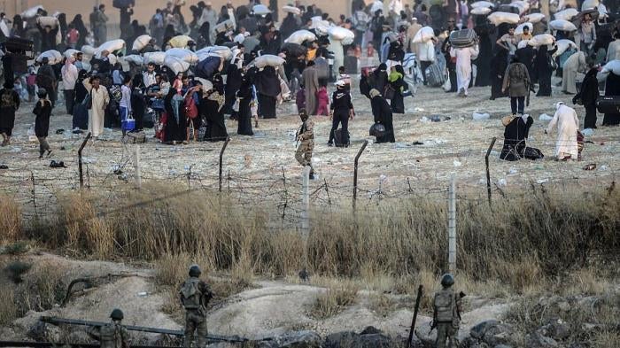 At Tal Abyad –Akçakale border crossing, in June 2015, Turkish border guards manning Turkey’s closed border watched ISIS fighters order displaced Syrian civilians back from the border.
