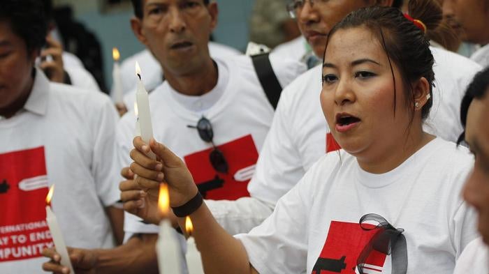 Shwe Hmone and other Burmese journalists pray at Sule Pagoda in Rangoon for colleagues killed or imprisoned for their work\.