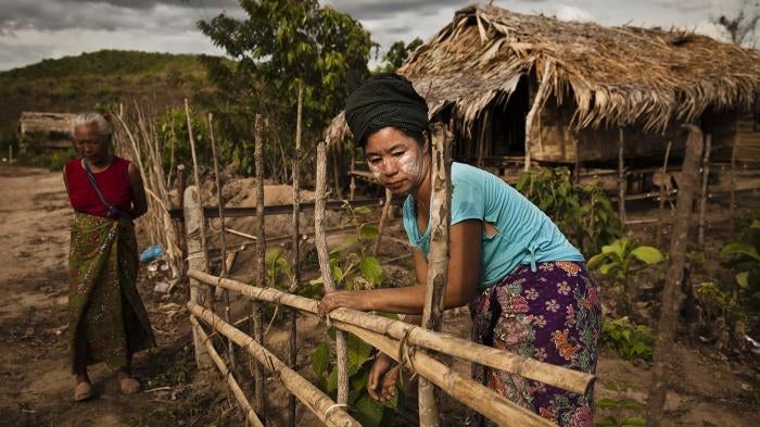 Two villagers in New Ahtet Kawin in front of their homes. 