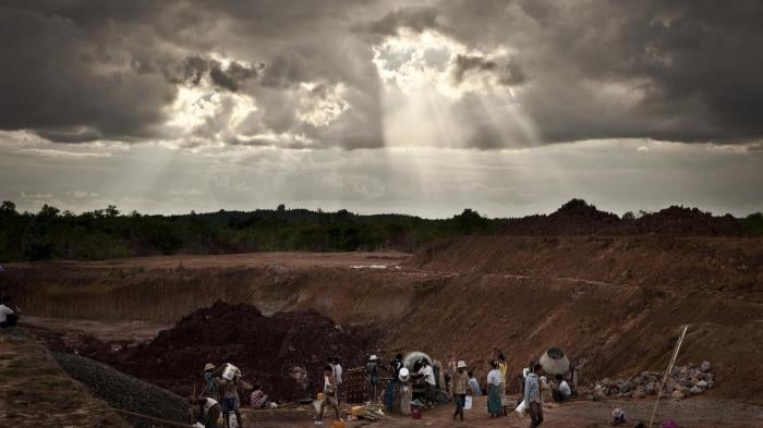 Workers build a water catchment area behind a governmentconstructed irrigation dam that flooded land belonging to Aung Thay and other villagers from Karen State. To date, the government has not paid compensation to the villagers who lost land. 