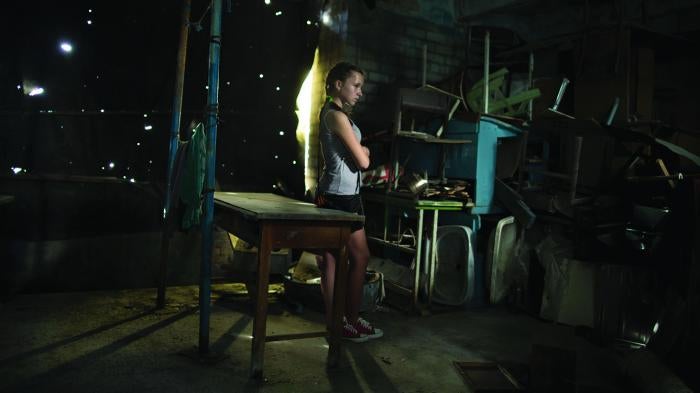 Cover imageA former student, 13, stands in a damaged school in Vuhlehirsk.