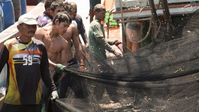 Fishers clean and prepare nets at a port in Phuket, Thailand, March 2016. 