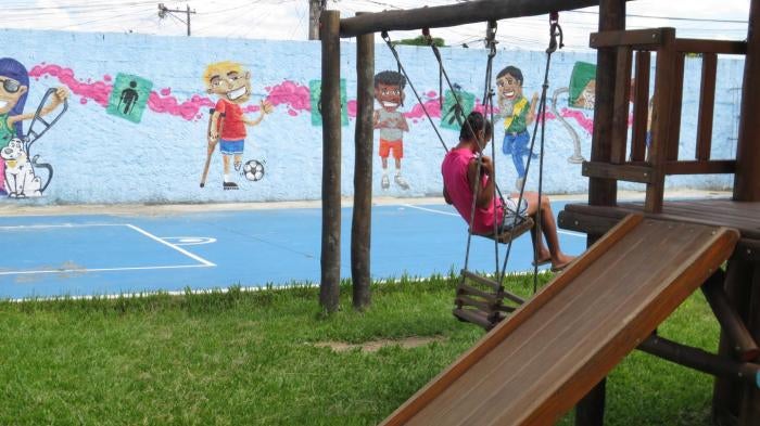 A girl with a disability in the walled yard of an institution for people with disabilities in Rio de Janeiro.