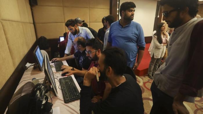 With communications shut down, journalists work inside a media center in Srinagar set up by Jammu and Kashmir authorities, August 18, 2019. 