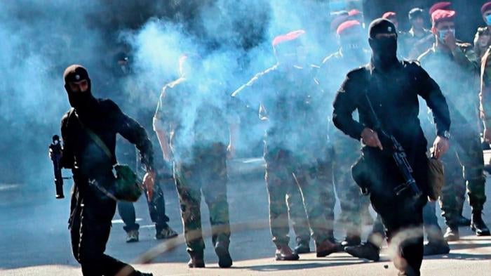 Iraqi security forces fire tear gas to disperse protesters during a demonstration in Baghdad, Iraq, Friday, Oct. 25, 2019. 